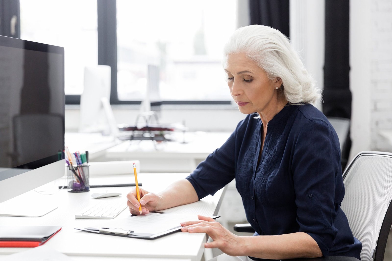 mature-business-woman-making-notes-piece-paper.jpg